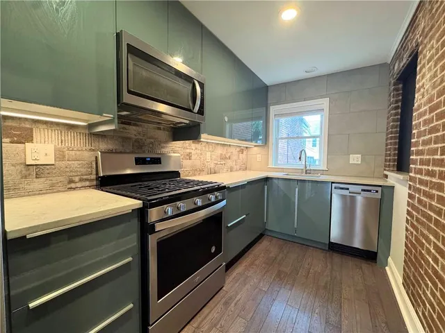 a kitchen with a stove and a microwave