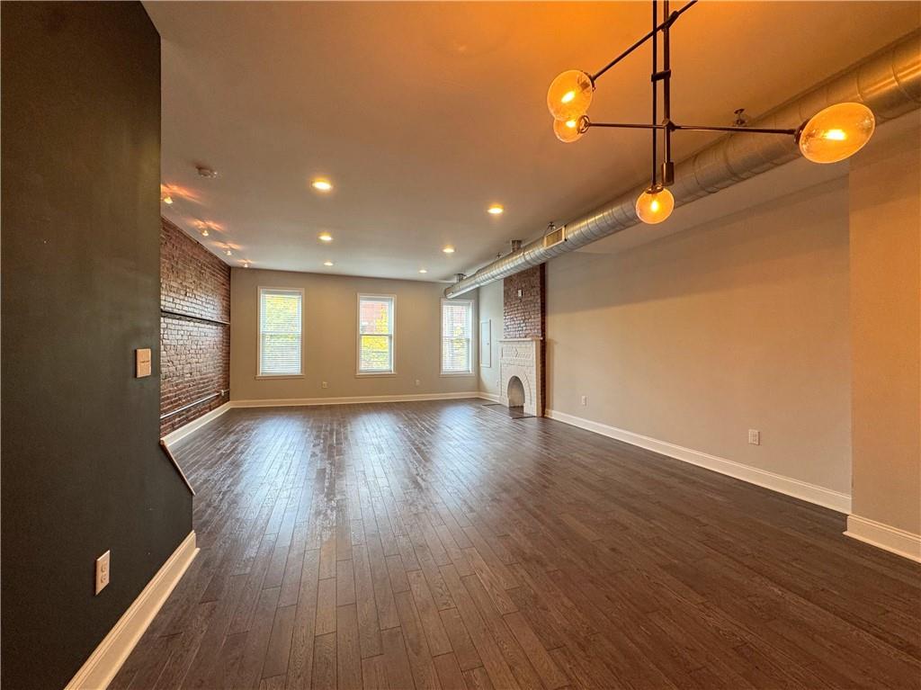 5208 Butler Street, Unit 2 Pittsburgh, PA 15201 - Photo 3 of 6 a view of a room with wooden floor and window