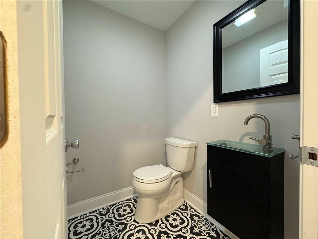 5208 Butler Street, Unit 2 Pittsburgh, PA 15201 - Photo 5 of 6 a bathroom with a toilet a sink and mirror
