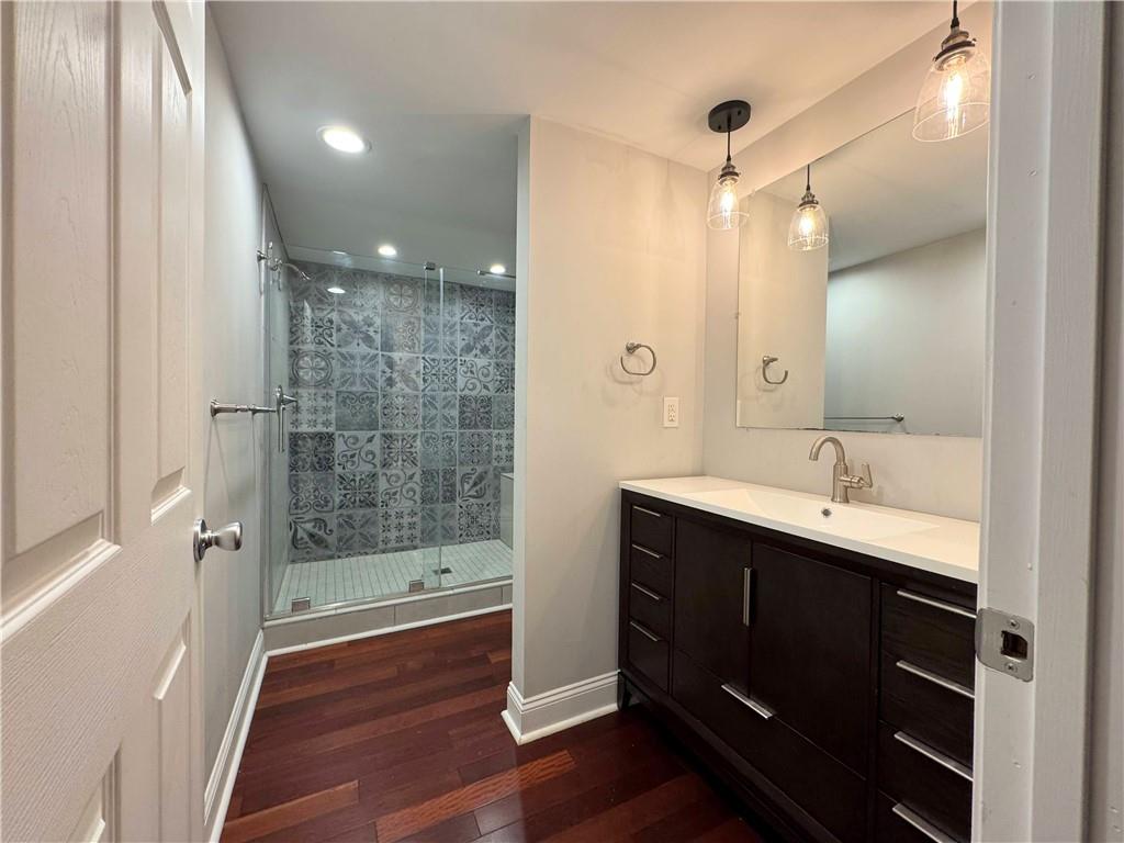 5208 Butler Street, Unit 2 Pittsburgh, PA 15201 - Photo 6 of 6 a bathroom with a shower sink and mirror