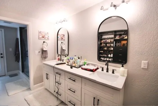 a bathroom with a double vanity sink and a mirror