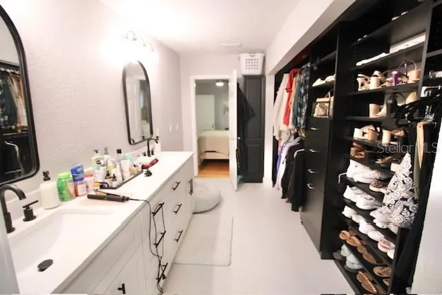 a bathroom with double vanity sink and a mirror