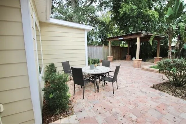 a view of backyard with outdoor seating and green space