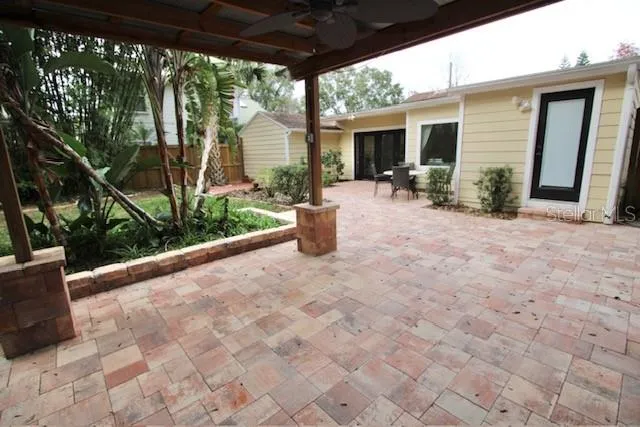a view of a patio with chairs and floor to ceiling window