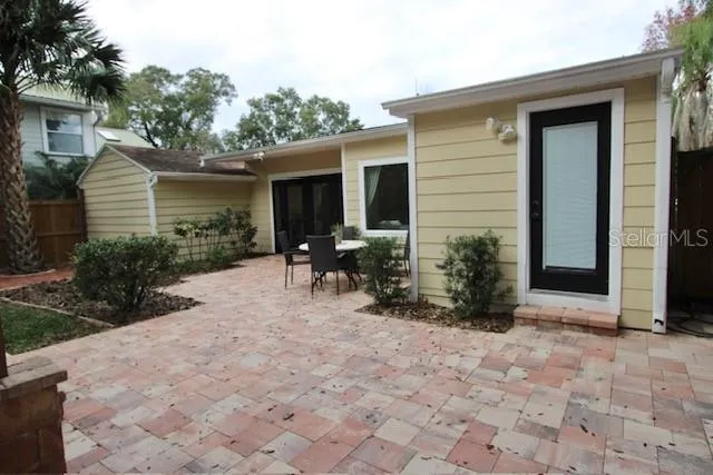 a view of a house with backyard and sitting area