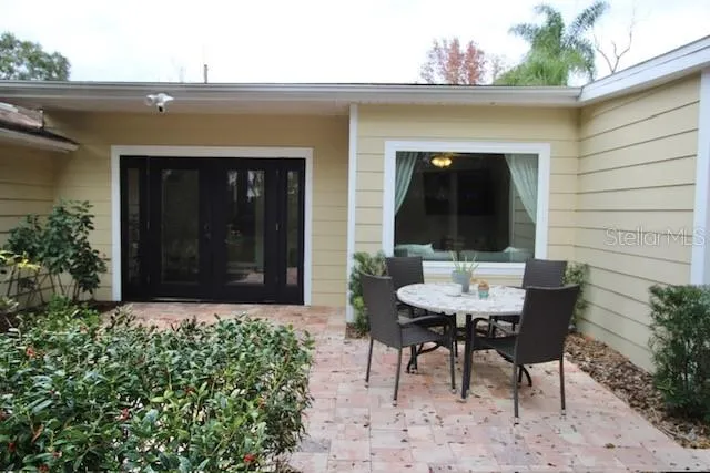 a view of a chair and table in the backyard of the house