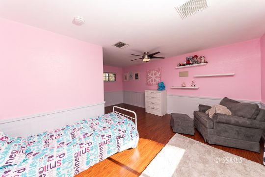 223 West Cobblestone Lane Ridgecrest, CA 93555 - Photo 24 of 34 a bedroom with a bed and a couch