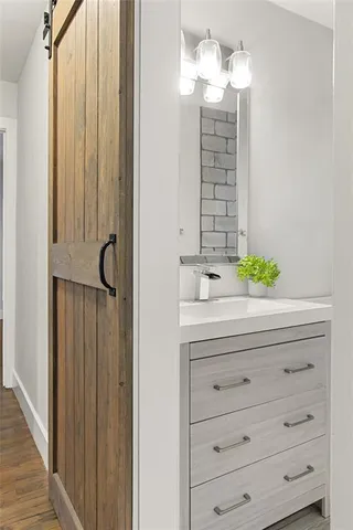 a bathroom with a sink vanity and a mirror