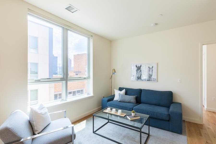 a living room with furniture and a large window