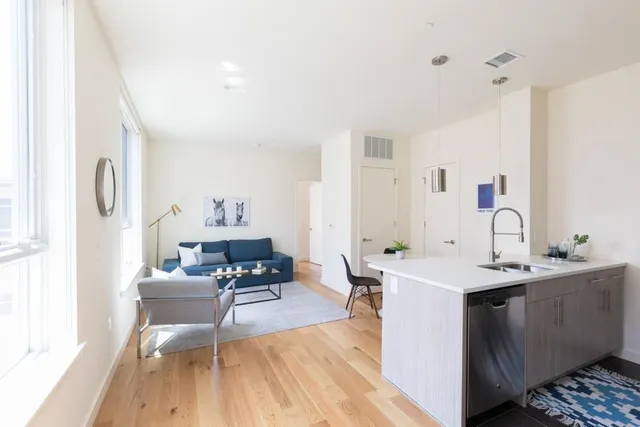 a living room with furniture a dining table and a sink