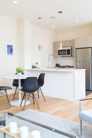 a living room with furniture a mirror and a window