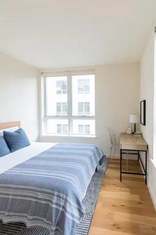 a wooden floor in a room next to a window
