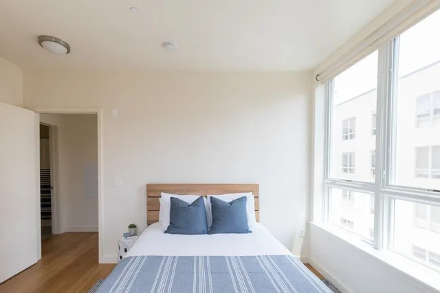a living room filled with furniture and a large window