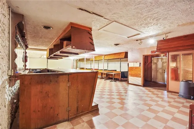 a kitchen with stainless steel appliances granite countertop a stove a refrigerator and a microwave