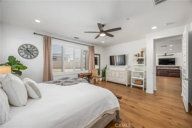 a bedroom with a bed and a television