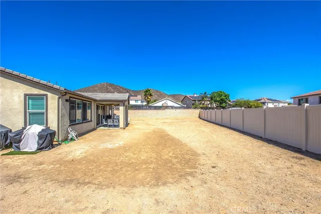a view of house with yard and seating area