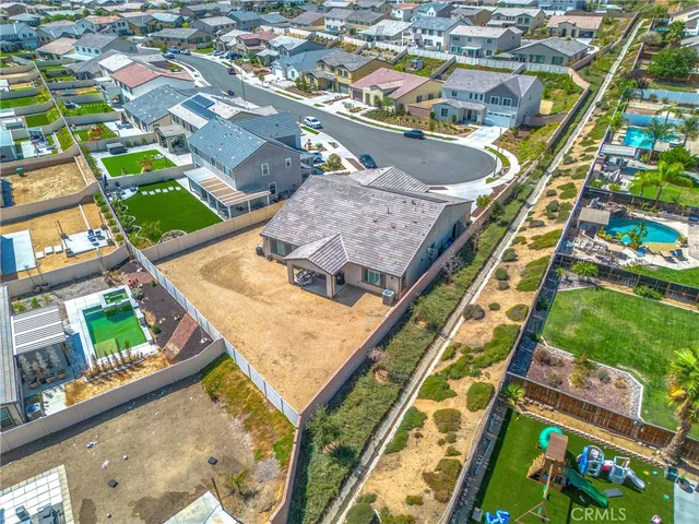 an aerial view of a residential houses with outdoor space and street view