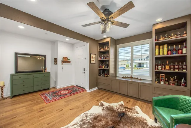 a bedroom with a bed cabinets and a window