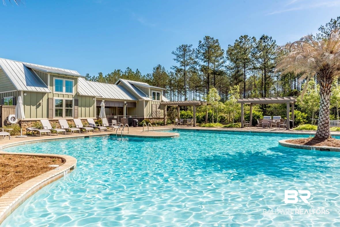 32125 Lyon Road Daphne, AL 36527 - Photo 58 of 70 Expansive resort-style swimming pool featuring integrated steps and a surrounding brick paver deck
