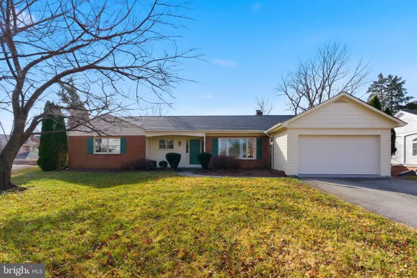 a front view of a house with yard and garage