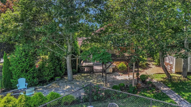 a view of a backyard with sitting area