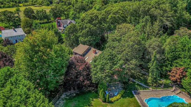 a backyard of a house with a yard and outdoor seating