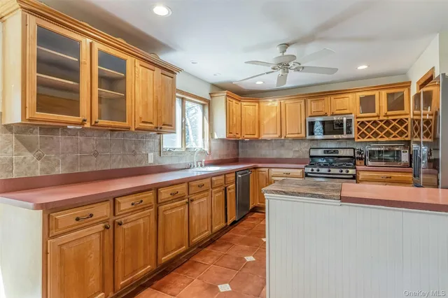 a kitchen with stainless steel appliances granite countertop a sink and cabinets