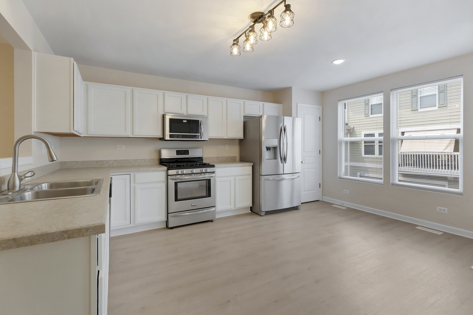 2441 Emily Lane Elgin, IL 60124 - Photo 10 of 27 a kitchen with stainless steel appliances a refrigerator sink and white cabinets