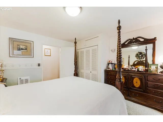 a bedroom with a bed and a dresser