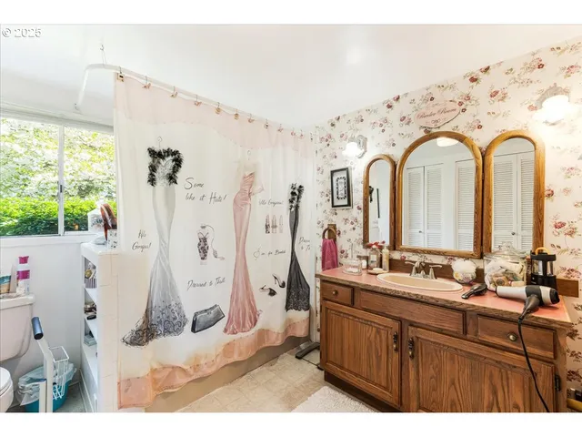 a bathroom with a double vanity sink mirror and