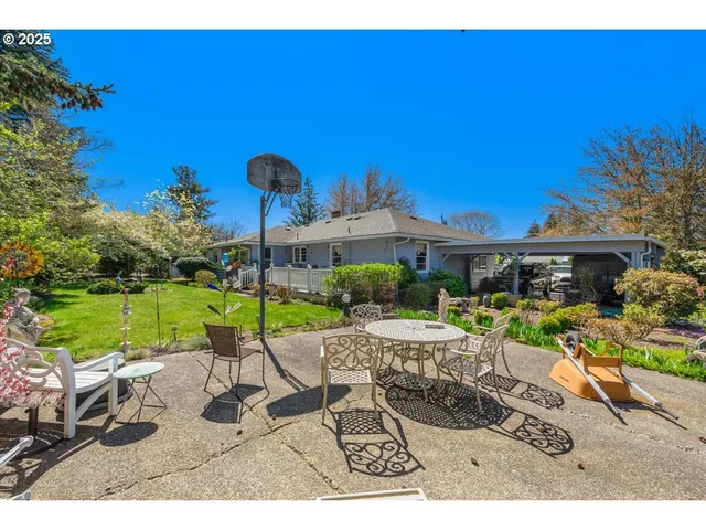 a view of a house with backyard porch and sitting area