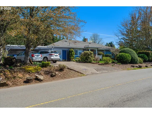 a front view of a house with a garden