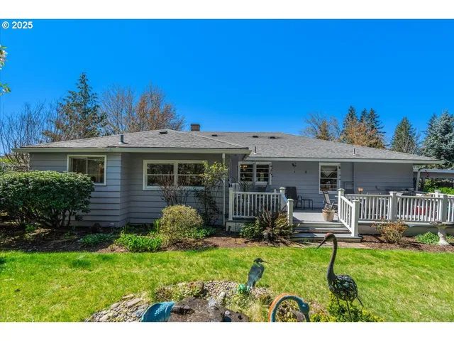 a view of a house with backyard sitting area and garden