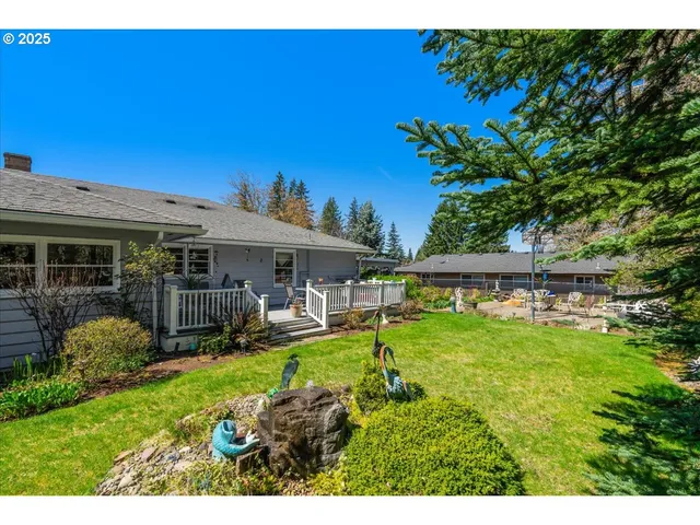 a view of a house with backyard sitting area and garden