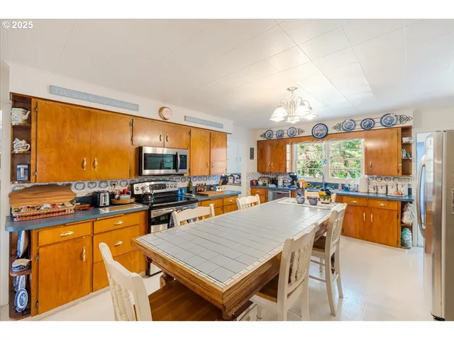 a living room with furniture a flat screen tv and a dining table