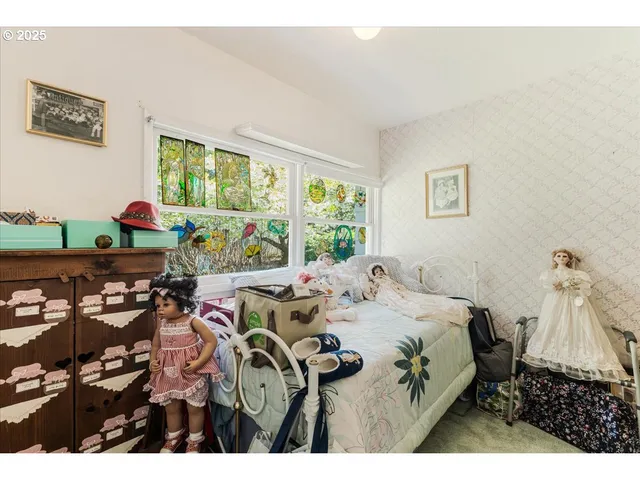 a bed sitting in a bedroom next to a window