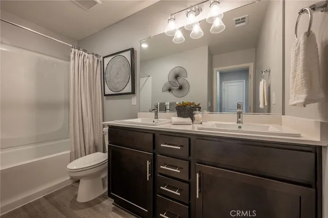 a bathroom with a toilet a sink and a mirror