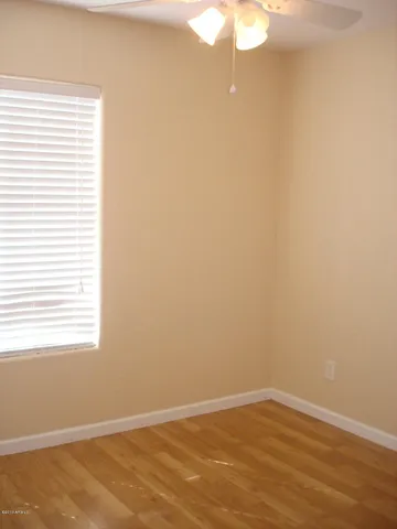 a view of a small space with wooden floor