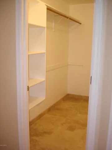 a kitchen with stainless steel appliances granite countertop a stove top oven a refrigerator and a microwave