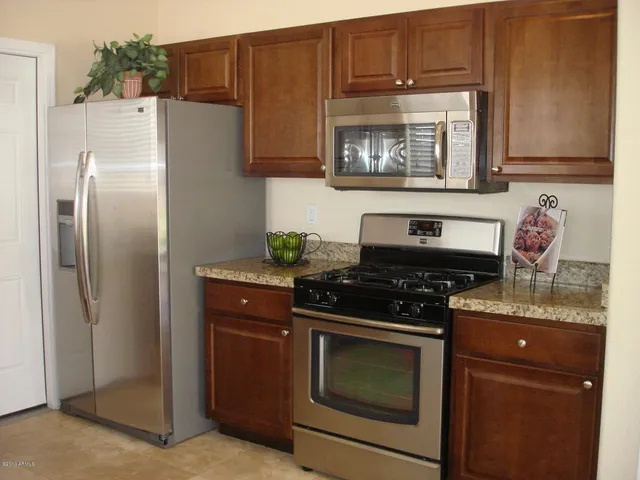 a stove top oven sitting inside of a kitchen