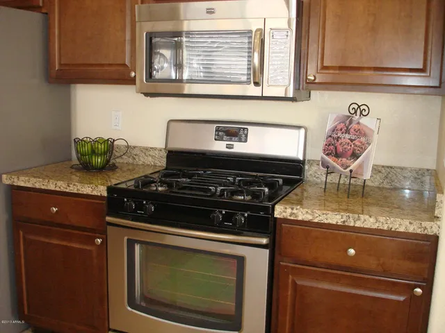 a kitchen with granite countertop cabinets sink and window