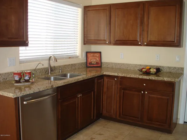 a front view of a house with a garden and yard