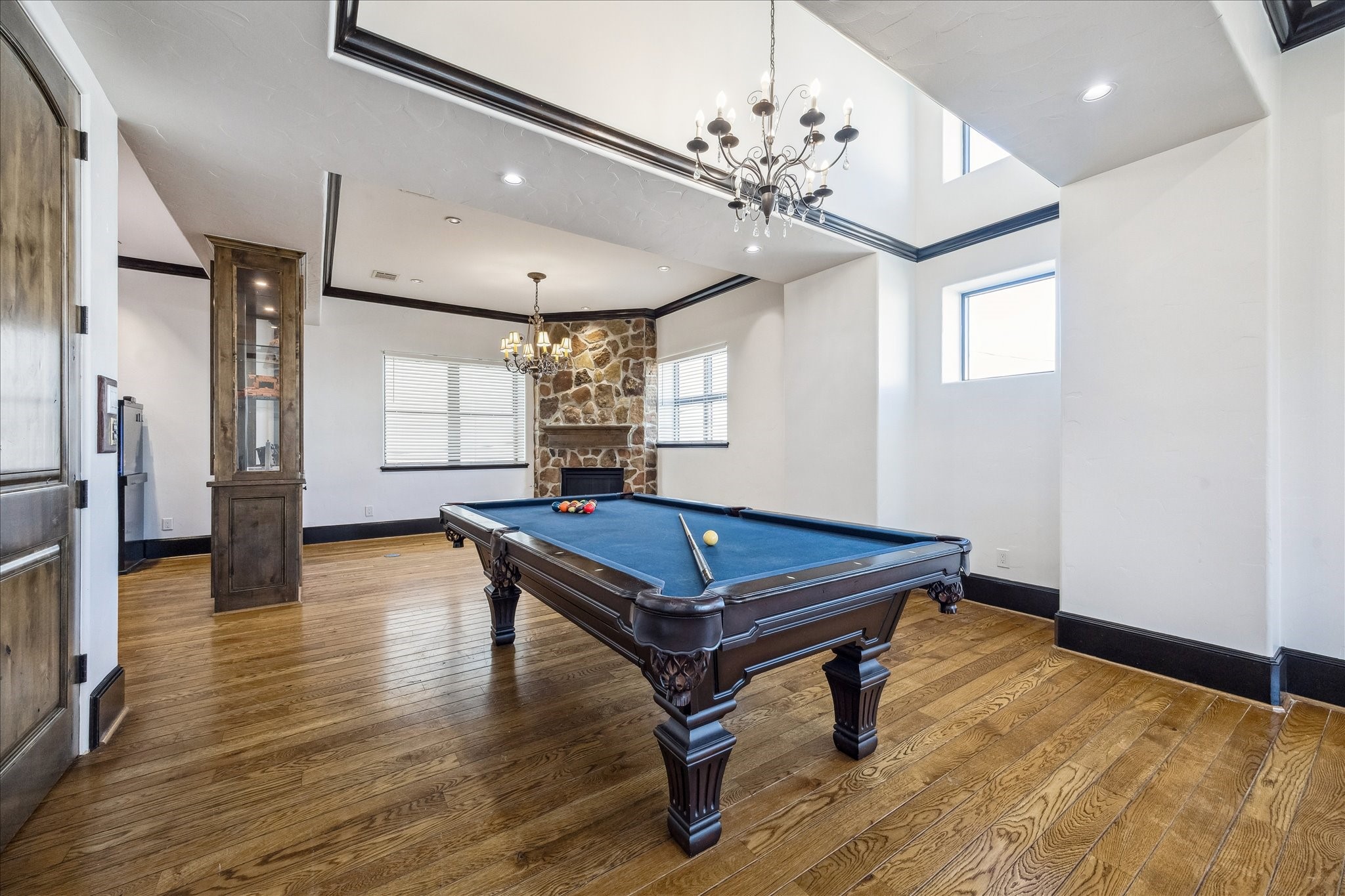 4119 Allen Street Houston, TX 77007 - Photo 19 of 42 a room with wooden floor pool table gym equipment and windows