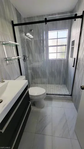 a bathroom with a sink toilet and mirror