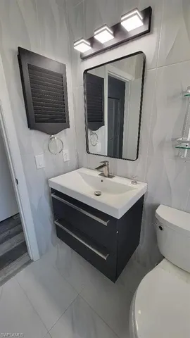 a bathroom with a sink a toilet and a shower