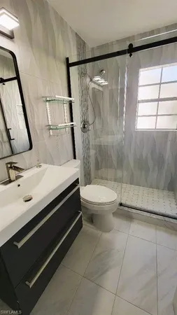 a bathroom with a sink a mirror and shower