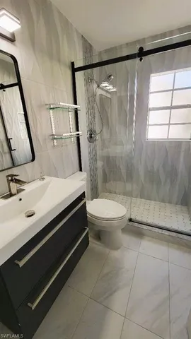 a bathroom with a sink a mirror and shower