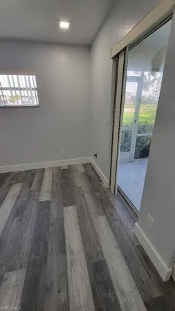 a view of an empty room and a window