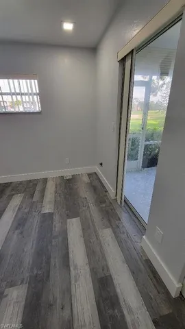 a view of an empty room and a window