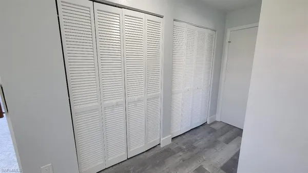 a view of walk in closet with empty racks